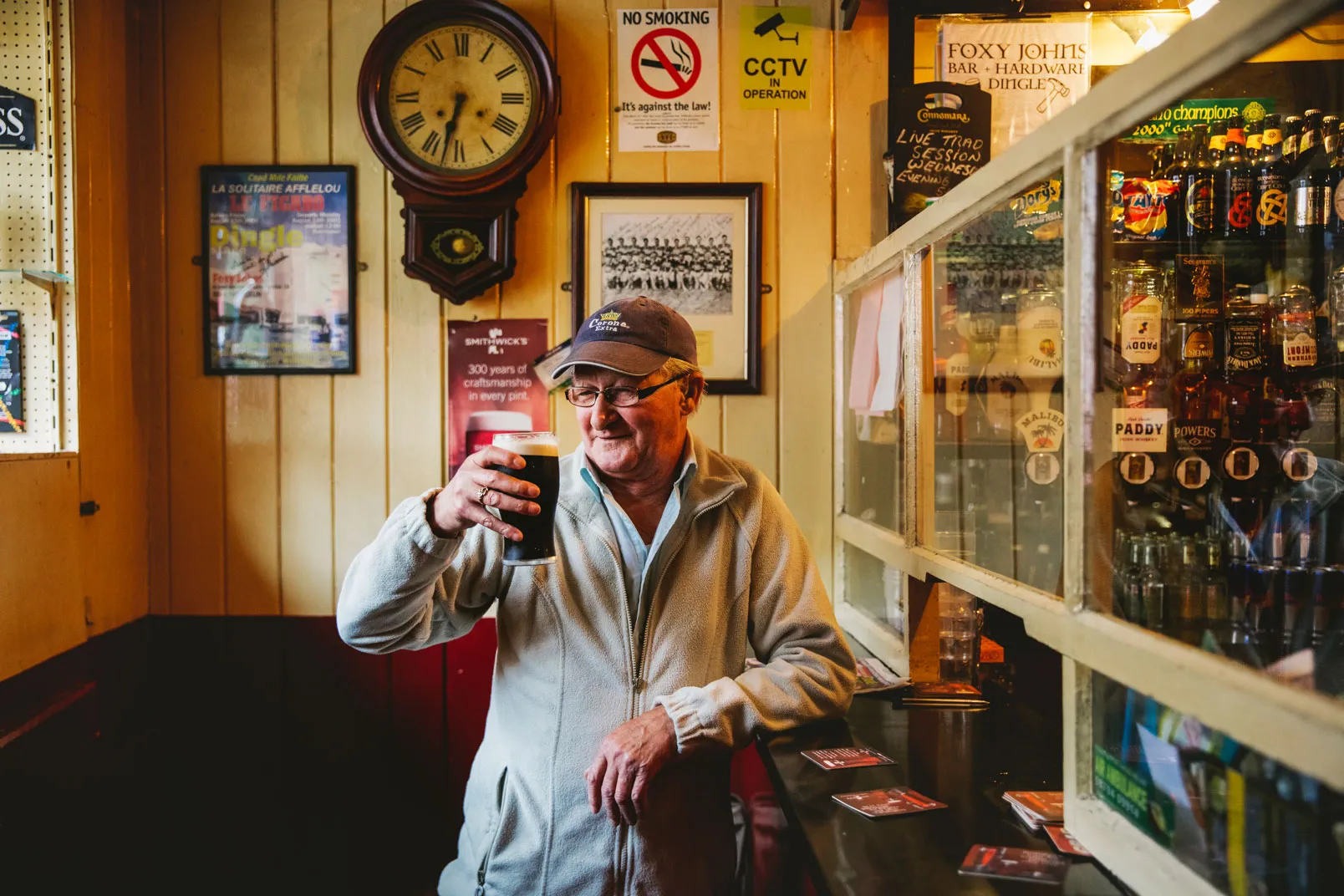 A local raising a pint in the snug at Foxy John's
